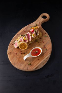 Tahta arka planda kızarmış ton balığı ve risotto.