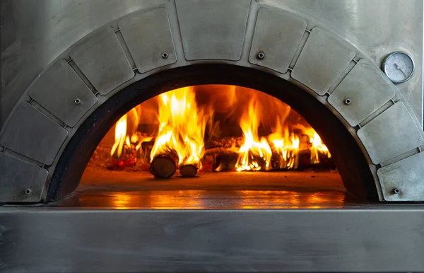 A fire is burning in a pizza oven. selective focus