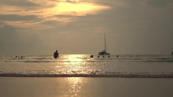 Slunce vstává nad krásné pláže v Thajsku, jak vlny umýt po písku. — Stock video