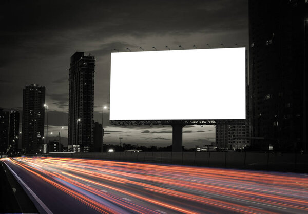 blank billboard on the highway, blank billboard during the twilight light, blank billboard in city background. With clipping path on screen.- can be used for display your products or promotional