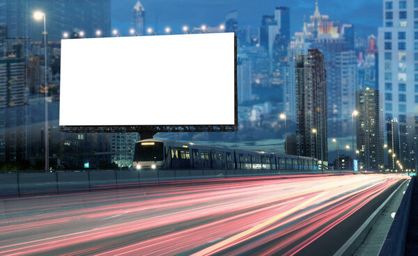 Blank billboard on the highway during the twilight with city background And fireworks in the sky with clipping path on screen.- can be used for display your products or promotional.