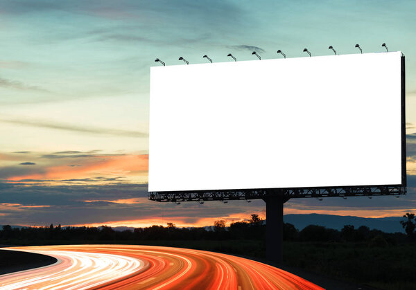 Blank billboard on the highway during the twilight. With clipping path on screen - can be used for trade shows, and advertising or promotional poster for you.