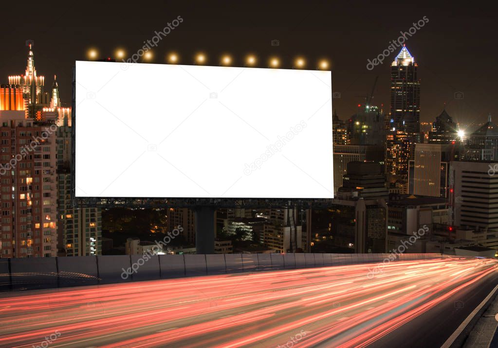 Blank billboard on the highway during the twilight with city background with clipping path on screen.- can be used for display your products or promotional