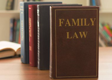 Family Law books on desk in the law firm. Legal education concept. clipart