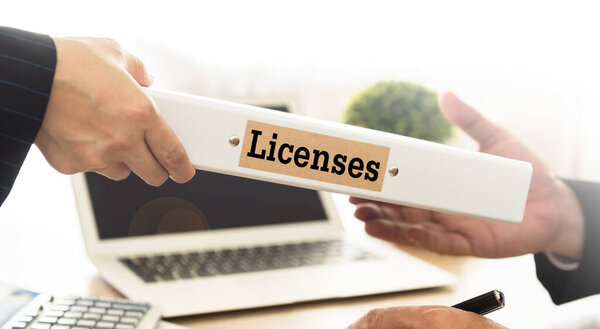 Licenses Concept. Staff send licenses folder to business people.