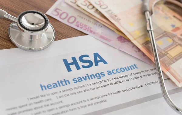 health savings account HSA concept with application form,euro money, stethoscope on desk.