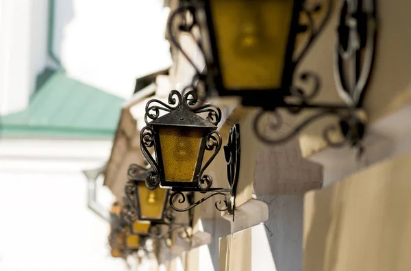 Street wrought-iron lamps with  along the house