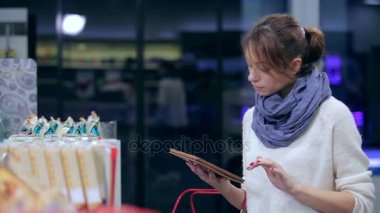 Kız bir tablet ürünleriyle seçer.