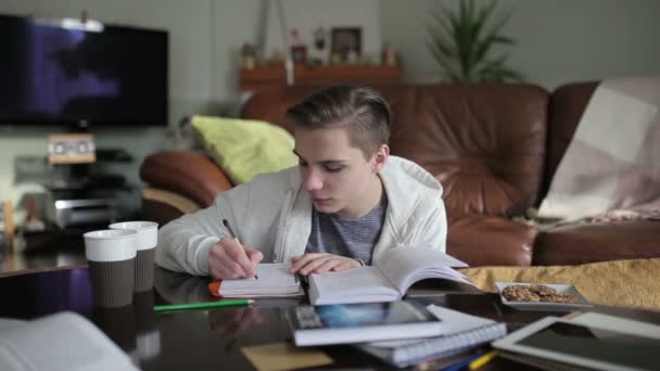 Male student writes down notes — Stock Video