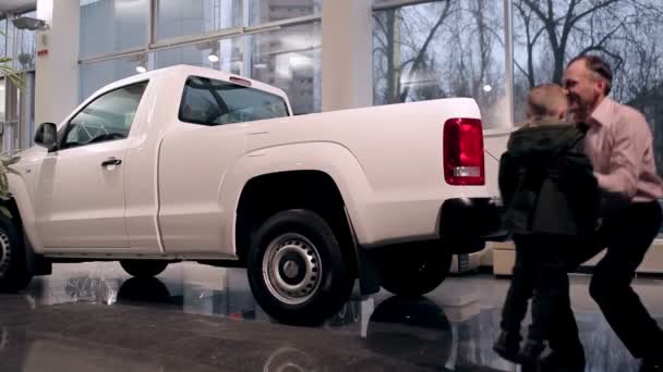 Sales Manager Helping Little Boy Get Pickups Body — Stock Video