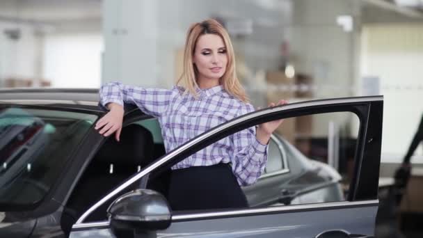woman posing behind new car