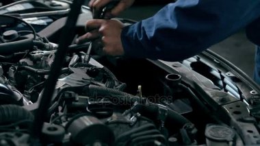 Tamirci araba motoru tamir ediyor