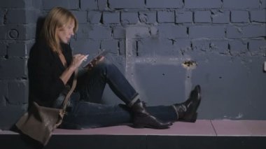 blonde woman using digital tablet