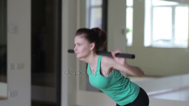 Girl performs exercises with a broomstick — Stock Video