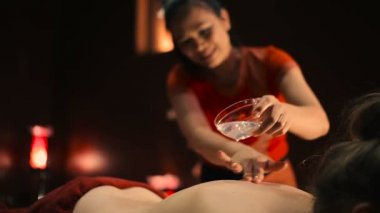 Asyalı kadın kırmızı üniformalı yağ spa salonda ile geleneksel Tay masajı yapıyor