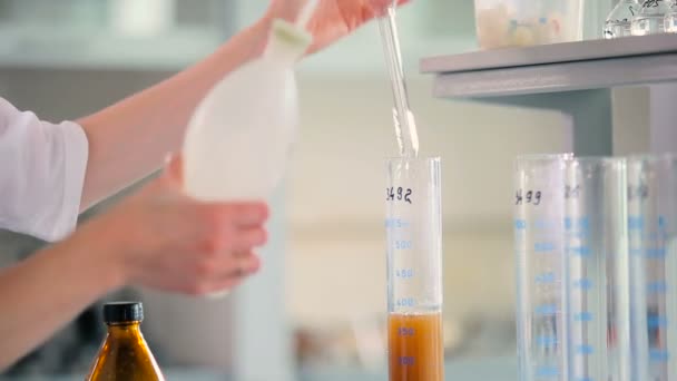 現代実験室の試験管で活躍する白い制服の女性 — ストック動画