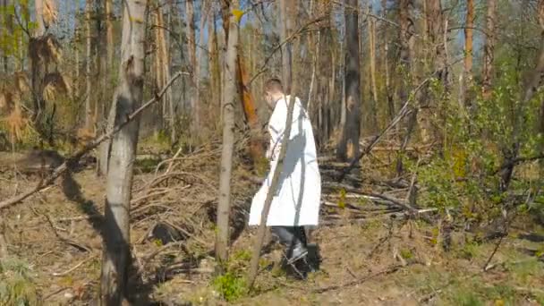 Man White Uniform Walking Forest Sunny Day — Stock Video