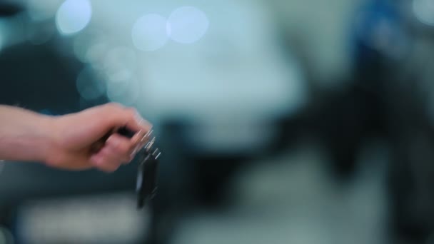 ディーラーで新しい現代の車からキーを保持している男性と女性の手のクローズ アップ — ストック動画