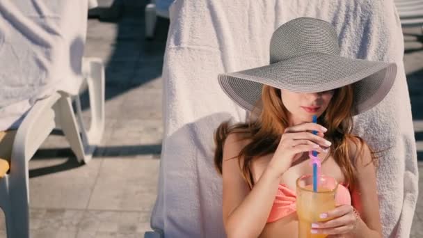 Молодая женщина пьет коктейль — стоковое видео