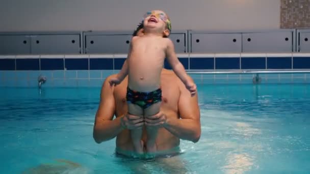 Pai jogar com menino na piscina . — Vídeo de Stock