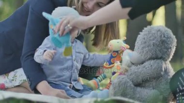 örtüm üzerinde oturan çocuk ile anne 