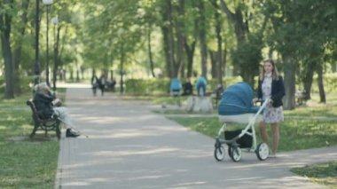 Young mother walking with pram