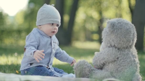 Charming boy looks at toy — Stock Video