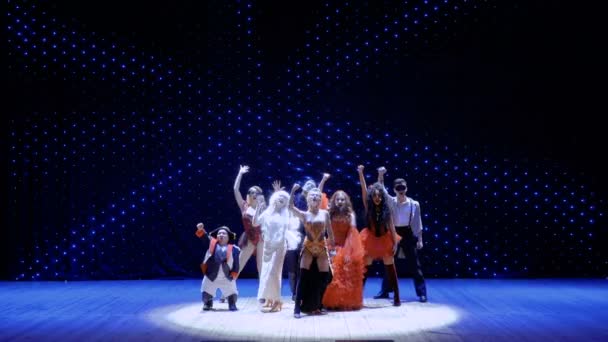 Artists dressed in scenic costumes are dancing on stage in light of spotlight — Stock Video