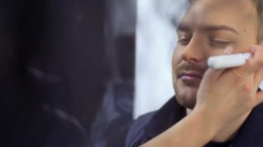 Makyaj sanatçısı adam performans için hazırlar.