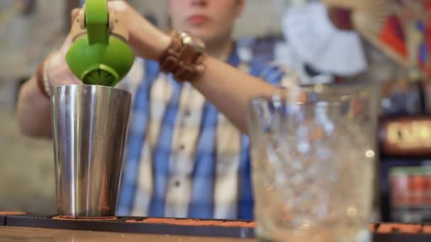 Бармен выжимает свежий лимонный сок для экзотического коктейля — стоковое видео