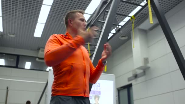 Тренер по спорту разговаривает со зрителями в спортзале на тренировке — стоковое видео