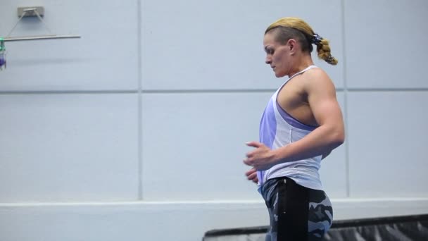Спортивная женщина делает дыхательные упражнения в тренажерном зале — стоковое видео