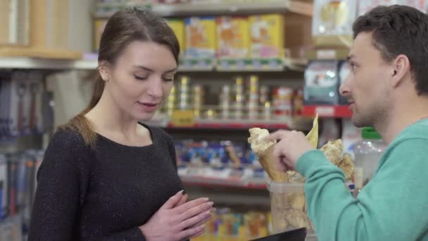 Hombre elige suplemento alimenticio para sus animales en la tienda de mascotas — Vídeo de stock