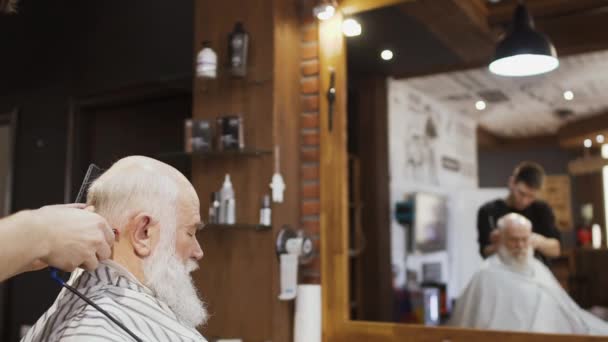 Professionale barbiere rende taglio di capelli moderno per l'uomo anziano — Video Stock