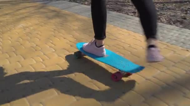 Girl in sneakers skateboarding on the road — Stock Video