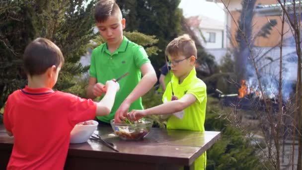 Τρία αδέλφια προετοιμάζει μπάρμπεκιου στον κήπο — Αρχείο Βίντεο
