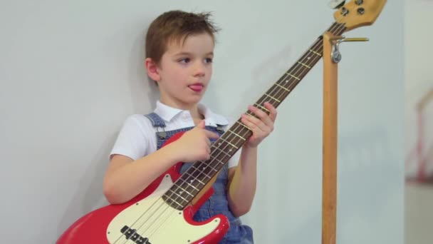 Cute little boy with electronic guitar — Stock Video