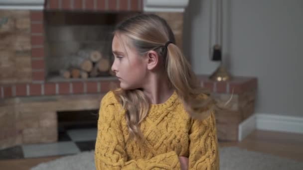 Upset Caucasian girl with crossed hands on chest turning away from the camera. Profile portrait of dissatisfied child in mustard sweater. — Stock Video