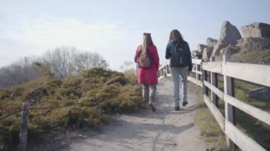 Kameralar Orta Doğulu bir adam ve beyaz bir kadını dışarıda tahta çitler boyunca yürürken izliyor. Sonbahar parkında çıkan pozitif hippi çift. Beraberlik, rahatlık, dinlenme..