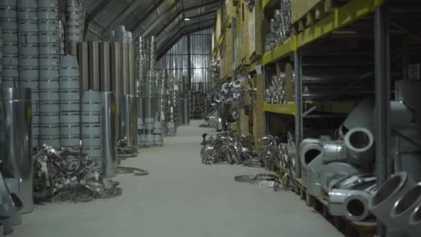 Steel metal pipes and metal items stored in warehouse. Ready production stored in freight terminal. Steel industry, metal production, manufacturing. Camera moving from right to left. — Stock Video