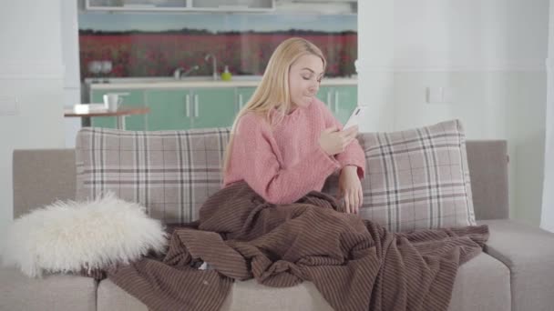 Porträtt av missnöjd vit kvinna skriva på smartphone och tänka. Blond tjej grälar med pojkvän på nätet. Relationsproblem, Internet, kommunikation. — Stockvideo