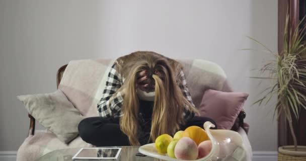 Upset Caucasian girl sitting on couch holding head with hands. Portrait of stressed teenager having problems. Adolescence, transitional age. Cinema 4k ProRes HQ. — 비디오