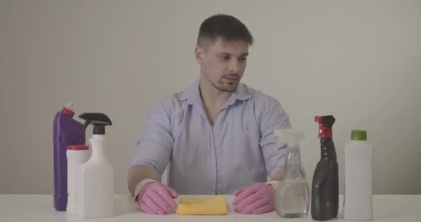 Portrait of brunette Caucasian man looking at cleansing agents and showing thumb up. Confident handsome guy approving detergents for cleaning. Housekeeping., lifestyle, household. Cinema 4k ProRes HQ. — Stock Video