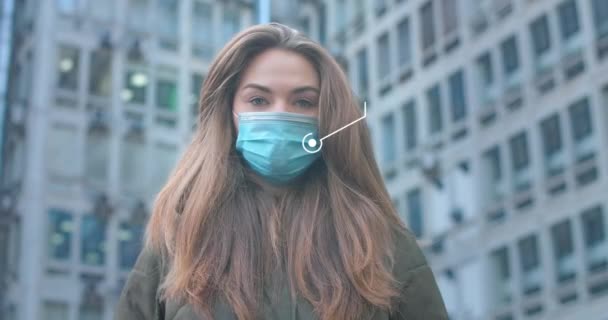 Portrait of beautiful Caucasian woman with 2d animation Covid-19. Young girl wearing protective mask in city at the background of buildings. Coronavirus, epidemic, pandemic. Cinema 4k ProRes HQ. — Stock Video