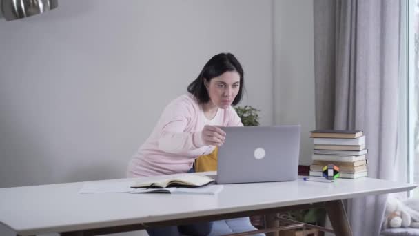 Portrait d'une femme blanche adulte ouvrant un ordinateur portable et regardant l'écran avec un visage surpris. Jeune femme brune espionnant des parents à l'intérieur. Secret, intimité, confiance, style de vie . — Video