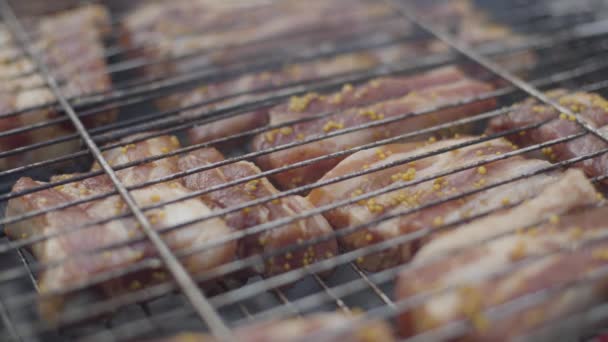 Raw spiced meat lying in bbq grid. Cooking of fresh delicious pork ribs on barbecue grill outdoors. Picnic, food, meal, cookout. — Stock Video