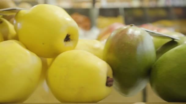 Camera moving along fresh juicy fruits on grocery shelf. Tasty healthy food lying for sale in supermarket. Concept of vegetarianism, vitamin products, healthful eating. — Stock Video