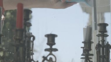 Beyaz adam pencereyi elle temizliyor. Camdan ateş ediyor. Şeffaf, şeffaf pencerenin arkasında duran mumlarla şamdan. Oda servisi, temizlik, yaşam tarzı..
