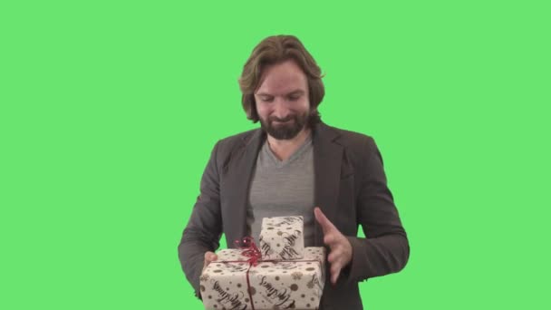 Middle shot of cheerful Caucasian man rejoicing and making victory gesture holding two elegant present in hands. Portrait of happy adult brunette guy smiling at camera. Joy, holiday. Chromakey. — Stock Video