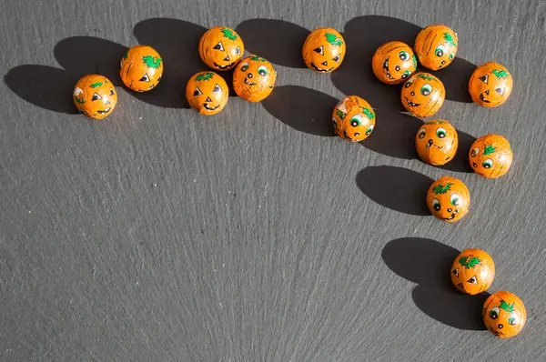 stock image Pumpkin candy balls with shadows on slate.